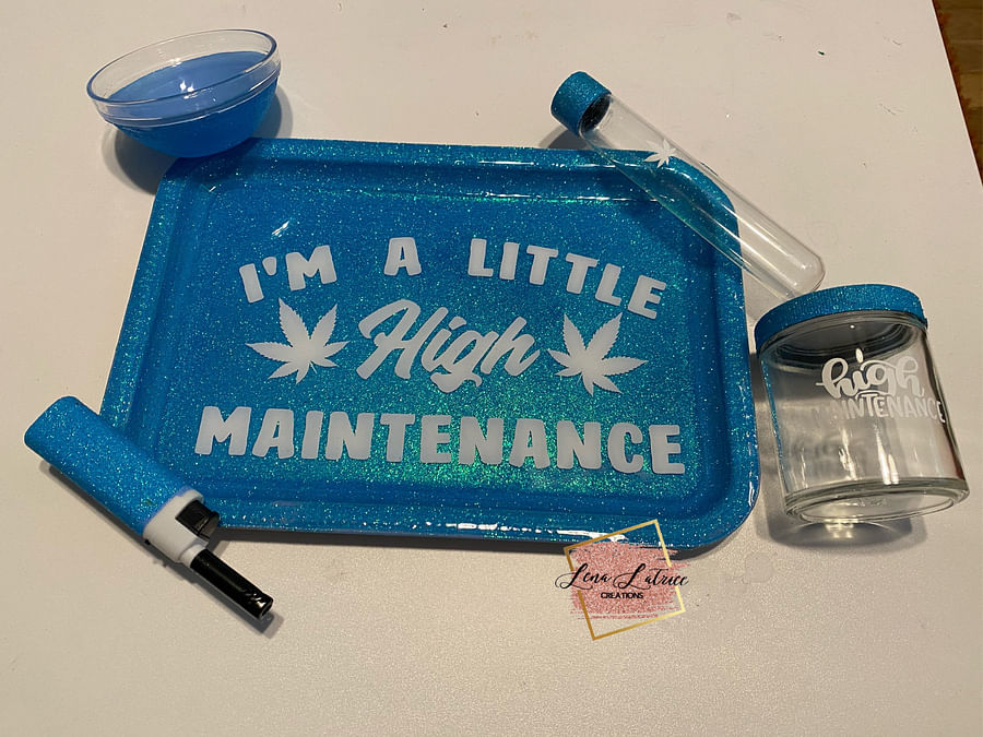 Collection of personalized cannabis accessories including custom bongs, dab rigs, and branded lighters